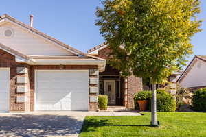 View of front of property featuring driveway and a front lawn