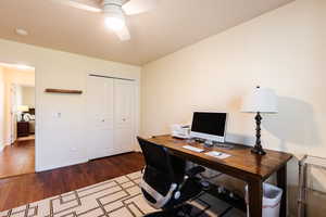 Office space featuring dark wood-style floors and a ceiling fan