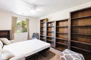 Bedroom featuring a ceiling fan and light carpet