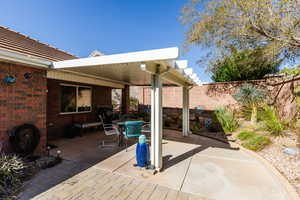 Fenced backyard with outdoor dining space, a patio area, and grilling area