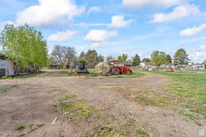 View of yard featuring a greenhouse and an outdoor structure