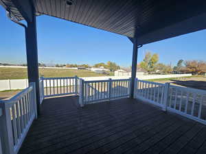 Wooden terrace featuring a fenced backyard and an outdoor structure