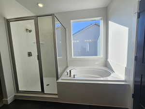 Bathroom with a bath and a stall shower