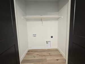 Laundry area with light wood-type flooring, hookup for an electric dryer, and hookup for a washing machine