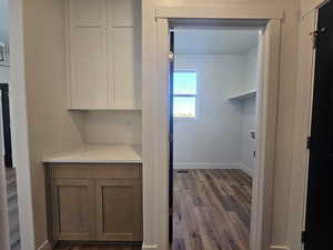 Laundry area featuring dark wood-style flooring and hookup for a washing machine