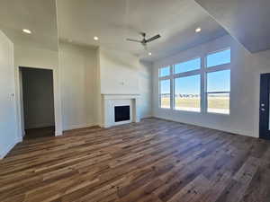 Unfurnished living room with recessed lighting, a fireplace, dark wood-style floors, and ceiling fan