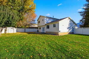 Back of house featuring a fenced backyard, a storage unit, and a patio area