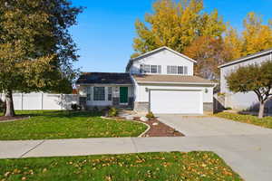 Traditional-style home featuring brick siding, driveway, and a garage