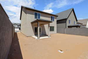 Back of property with a patio area, a fenced backyard, and stucco siding