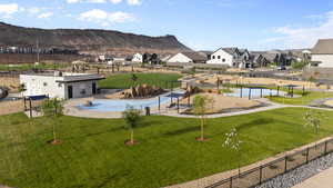 View of community with a pool, a patio area, a residential view, and a mountain view
