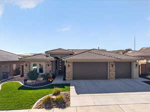 Prairie-style house with a garage, driveway, a tiled roof, and a front lawn