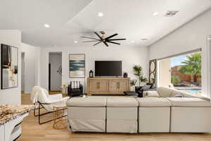 Living area featuring recessed lighting, light wood finished floors, a ceiling fan, and a textured ceiling