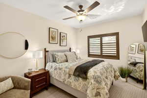 Bedroom with a ceiling fan and carpet flooring