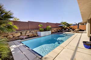 View of pool featuring a patio area and a fenced backyard