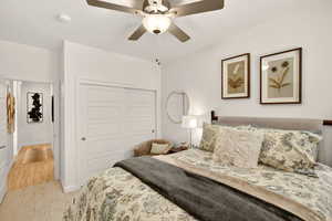Carpeted bedroom featuring a closet and a ceiling fan