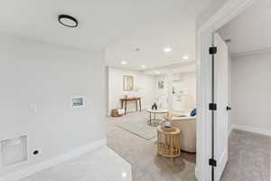 Hallway featuring recessed lighting and light colored carpet