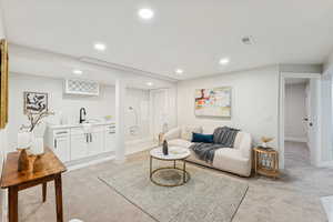 Living room with light colored carpet and recessed lighting
