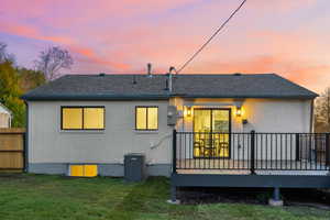 Rear view of property with a deck, brick siding, and a shingled roof