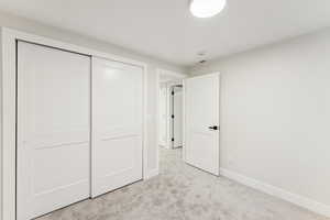 Unfurnished bedroom featuring carpet and a closet