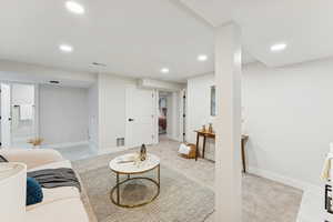 Living area featuring recessed lighting and light colored carpet