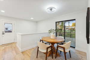 Dining area featuring light wood-style flooring and recessed lighting