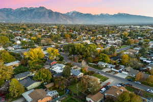 Aerial view of property's location with a mountain backdrop and nearby suburban area