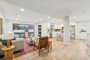 Living room featuring recessed lighting, light wood-style flooring, and attic access