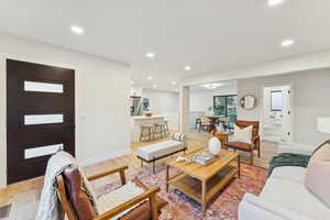Living room with light wood-style floors and recessed lighting