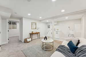 Living area featuring recessed lighting and light carpet