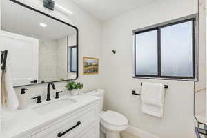 Bathroom with vanity and recessed lighting