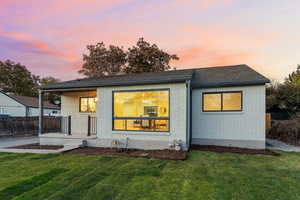 Back of house with brick siding and a shingled roof