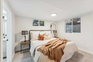 Bedroom with light colored carpet and ensuite bath