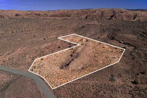 Aerial view of property's location featuring property parcel outlined and a desert landscape