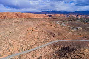 Aerial view of sparsely populated area with a desert landscape and a mountainous background