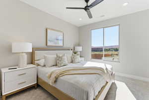 Bedroom featuring light carpet, a ceiling fan, and recessed lighting