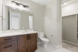 Half bath with vanity and a spacious closet
