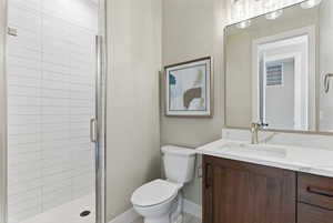 Full bathroom featuring vanity and a shower stall