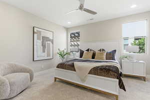 Bedroom featuring light colored carpet, a ceiling fan, and recessed lighting