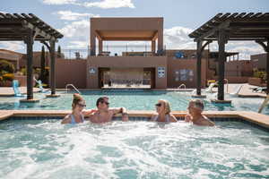 Community pool with a pergola, a community hot tub, and a patio