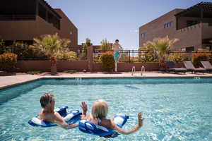 Community pool with a patio