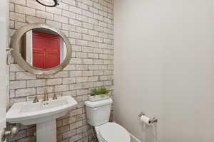 Bathroom featuring tile walls and tasteful backsplash