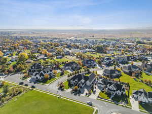 Aerial view of property and surrounding area with nearby suburban area