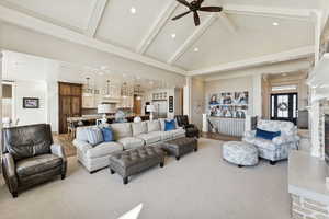 Carpeted living area with beam ceiling, high vaulted ceiling, recessed lighting, and a ceiling fan