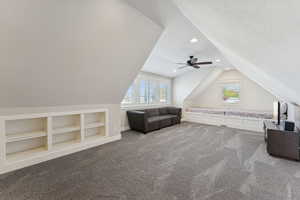 Additional living space featuring carpet flooring, lofted ceiling, built in features, recessed lighting, and a textured ceiling