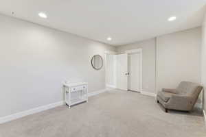 Unfurnished room with light colored carpet and recessed lighting