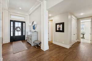 Entryway featuring dark wood-style floors, recessed lighting, and crown molding