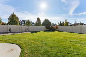 Fenced backyard featuring a residential view