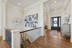 Entrance foyer featuring light wood finished floors, ornamental molding, and recessed lighting