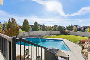 View of pool with a patio, a fenced backyard, a residential view, and a diving board