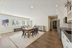 Dining room with recessed lighting and dark wood finished floors